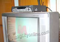 Set top box mounted on a television set
