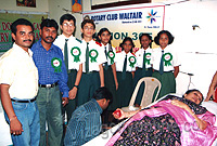 Principal Mrs. Sunitha Nair donating blood. Interact club members in the background.